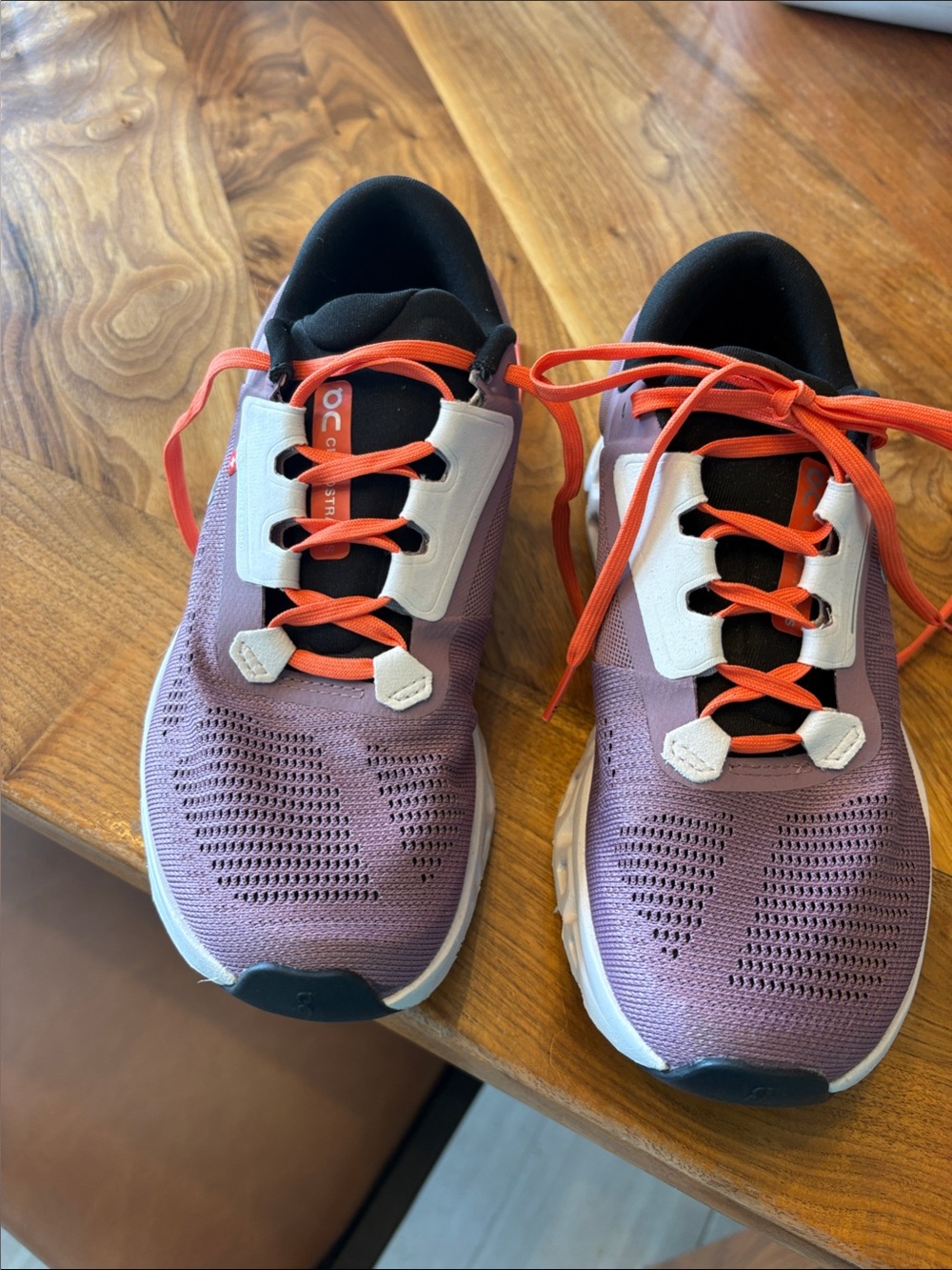 On Running CloudStratus Women’s Lavender Athletic Sneakers with Orange Laces.